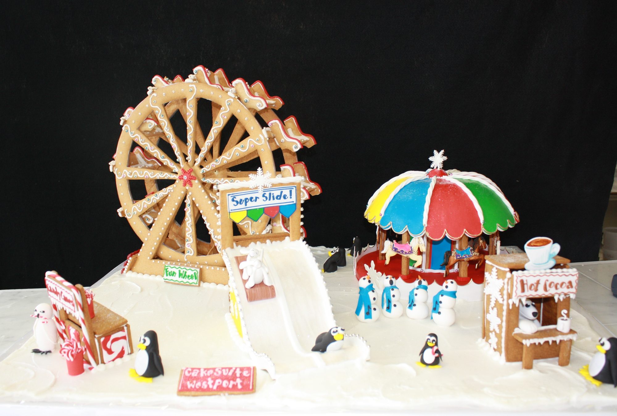 Winter carnival scene with a Ferris wheel and sugar penguins